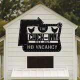 White chicken coop with a decorative metal sign on the side.