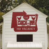White chicken coop with a red sign reading 'The Chick Inn No Vacancy' on a blurred green background.
