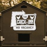 Chicken coop with 'The Chick Inn' sign on a blurred natural background
