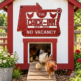 A decorative red and white chicken coop with a large metal sign reading 'The Chick-Inn No Vacancy' and several chickens walking out of the entrance on a wooden ramp in a garden setting.