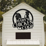 White chicken coop with a rooster logo and 'Mary's Chicken Coop' text on a wooden background.