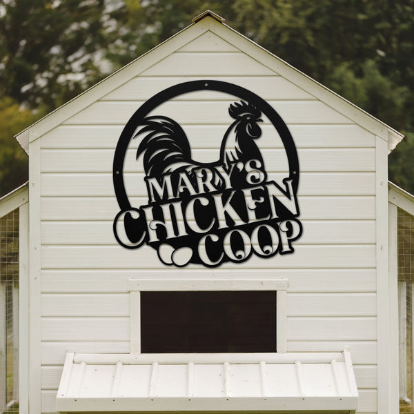 White chicken coop with a rooster logo and 'Mary's Chicken Coop' text on a wooden background.