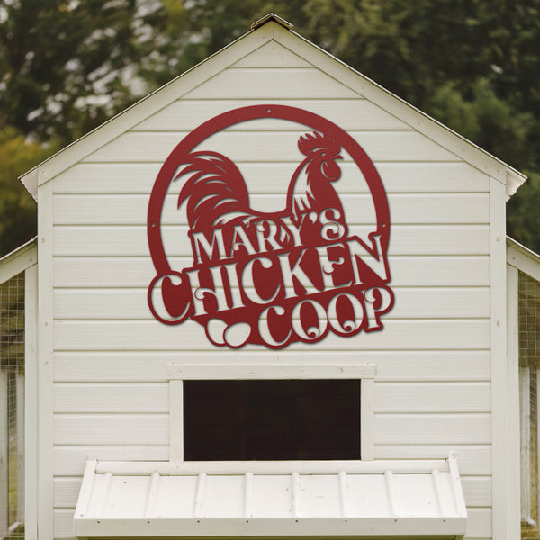 White chicken coop with a red rooster logo and 'Mary's Chicken Coop' text.