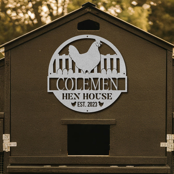 Brown hen house with a metal sign featuring a chicken and 'Colemen Hen House' text.