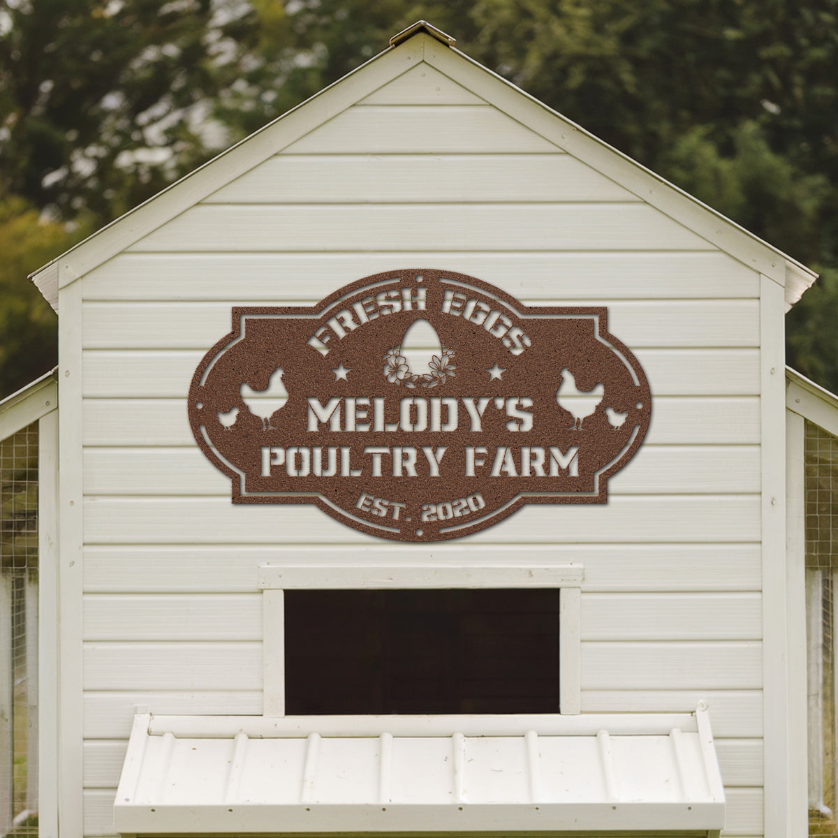 White chicken coop with 'Melody's Poultry Farm' sign on a blurred green background