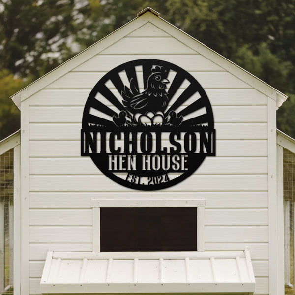White chicken coop with a black logo on the side, featuring text 'Nicholson Hen House'.