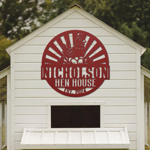 White chicken coop with a red 'Nicholson Hen House' logo on the side.