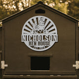 Brown hen house with a metal sign featuring a rooster and 'Nicholson Hen House' text.