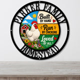 A circular metal wall sign with a black outer ring and a colorful central illustration. The sign reads “PARKER FAMILY” at the top and “HOMESTEAD” at the bottom, with a white chicken, red barn, flowers, and text including “Built by Hand,” “Run by Chickens,” and “Loved by All.