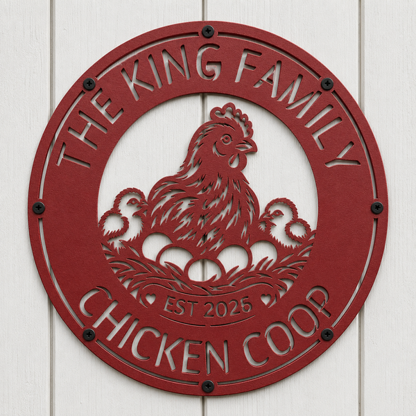 A round red metal wall sign featuring a cutout hen and chicks with the text 'THE KING FAMILY CHICKEN COOP' and 'EST 2025', mounted on a white wood plank wall.