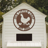 White chicken coop with a brown logo featuring a rooster and chickens on the side.