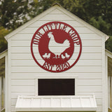 White chicken coop with a red logo featuring a chicken and chicks on a blurred green background