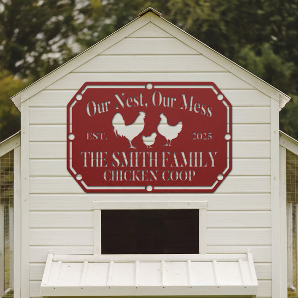 White chicken coop with a red sign featuring chickens and text, set against a natural background.