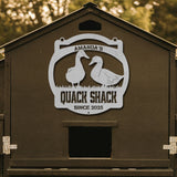 Brown duck house with 'Amanda's Quack Shack' sign featuring two ducks.