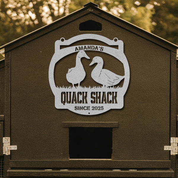 Brown duck house with 'Amanda's Quack Shack' sign featuring two ducks.