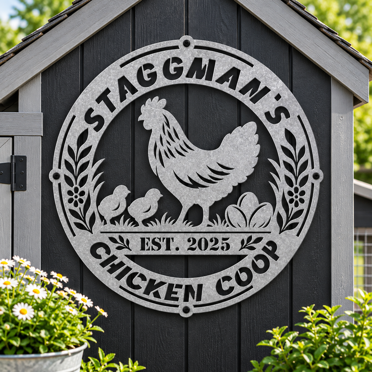 A large circular galvanized metal sign mounted on a dark gray wooden chicken coop, featuring a rooster, two chicks, eggs, and the text 'STAGGMAN'S CHICKEN COOP' and 'EST. 2025'.