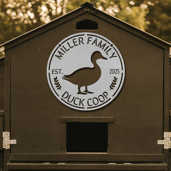 Duck coop with 'Miller Family Duck Coop' logo on a wooden background